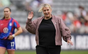 USWNT Head Coach Emma Hayes smiles and waves to the camera during warmups of one of the USWNT's games vs. South Korea.